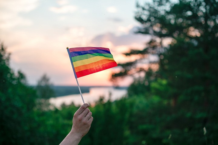 A pride flag held aloft